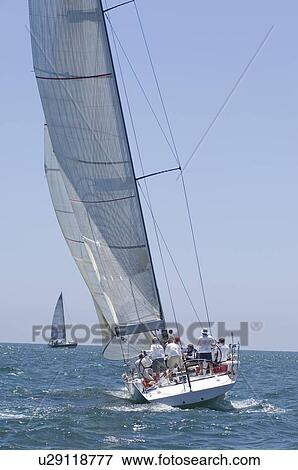 Stock Photo - Crew on board yacht in competitive team sailing event California. Fotosearch