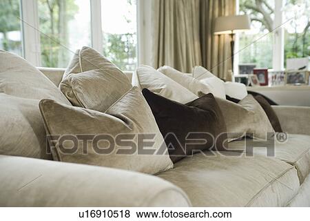 Stock Photo - Cushions on sofa in living room. Fotosearch