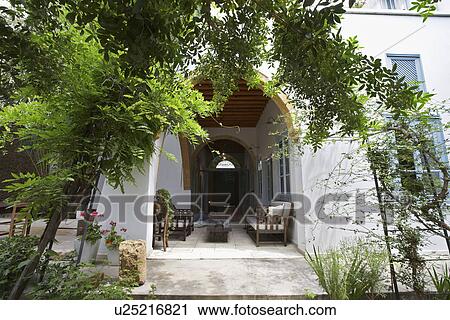 Stock Image - Cyprus garden patio and veranda of restored antique town house. Fotosearch