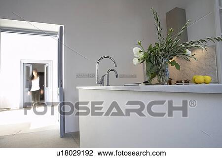 Stock Image - Cyprus kitchen of restored Mediterranean town house (woman in background). Fotosearch