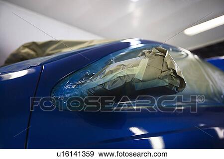 Stock Photo - Damaged headlight of blue car. Fotosearch