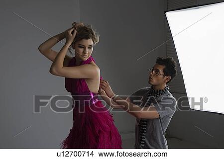 Designer Adjusting Dress Back on Fashion Model View Large Photo Image Picture - Designer Adjusting Dress Back on Fashion Model. Fotosearch
