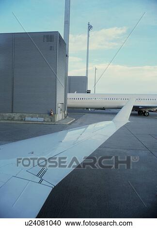 Stock Image - Detail of airplane wing in airport. Fotosearch