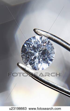 Diamond held by tweezers close-up View Large Photo Image Stock Image - Diamond held by tweezers close-up. Fotosearch
