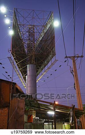 Stock Photo - Double Billboards Above Fenced Storage Enclosure. Fotosearch