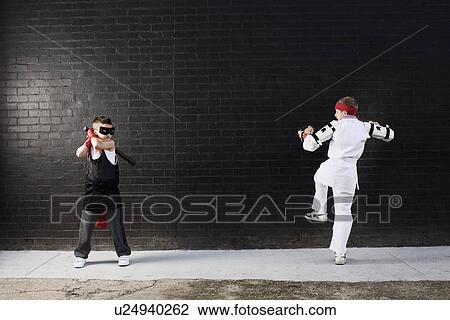 Dressed up boys pretending to fight View Large Photo Image Stock Image - Dressed up boys pretending to fight. Fotosearch