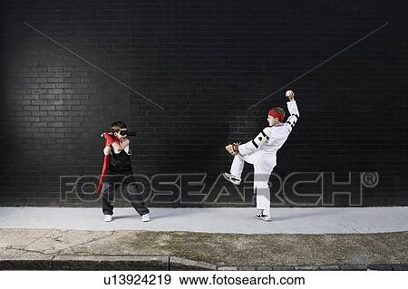 Stock Photo - Dressed up boys pretending to fight. Fotosearch