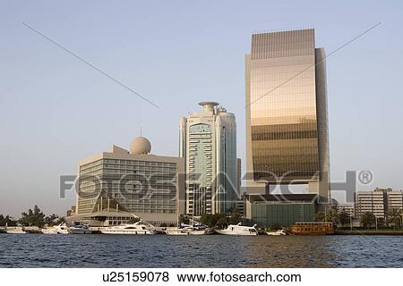 Dubai UAE Beautiful waterfront view of Deira’s skyline at sunset on Dubai Creek the shiny bronze. View Large Photo Image Stock Photo - Dubai UAE Beautiful waterfront view of Deira’s skyline at sunset on Dubai Creek the shiny bronze.. Fotosearch