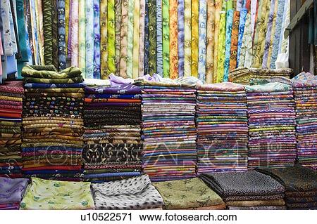 Stock Image - Dubai UAE Colorful fabrics are displayed for sale at the Al Naif souq in Deira.. Fotosearch