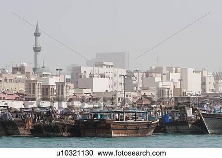 Dubai UAE Dhows old wooden sailing vessels are docked along the Deira side of Dubai Creek. View Large Photo Image Stock Image - Dubai UAE Dhows old wooden sailing vessels are docked along the Deira side of Dubai Creek.. Fotosearch