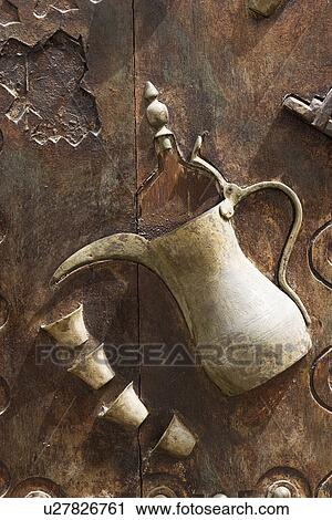 Stock Image - Dubai UAE Ornately decorated wood doors at Heritage Village in Bur Dubai. Fotosearch
