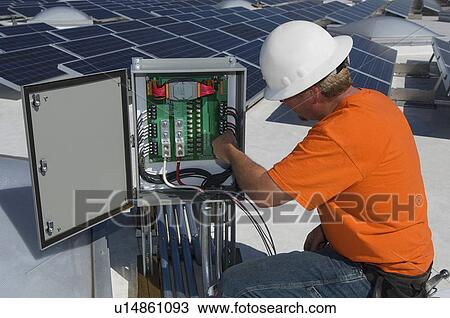 Electrical Engineer Among Solar Panels at Solar Power Plant View Large Photo Image Stock Image - Electrical Engineer Among Solar Panels at Solar Power Plant. Fotosearch