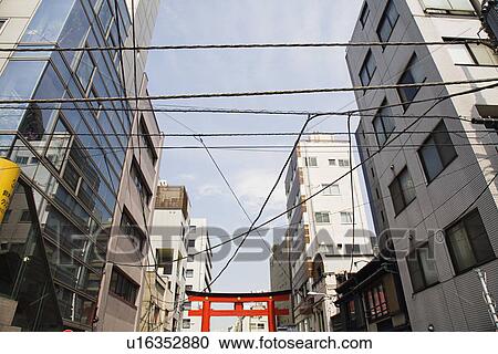 Electrical Lines and Torii Gate Between Multistory Buildings View Large Photo Image Stock Image - Electrical Lines and Torii Gate Between Multistory Buildings. Fotosearch