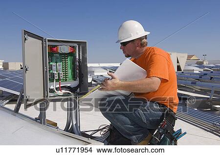 Engineer Working on Electrical Box at Solar Power Plant View Large Photo Image Picture - Engineer Working on Electrical Box at Solar Power Plant. Fotosearch