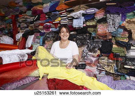 Stock Image - Fabric Store Worker. Fotosearch