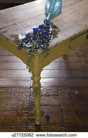 Stock Image - Fallen vase with flowers on table. Fotosearch