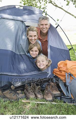 Family of four smiling from a tent View Large Photo Image Picture - Family of four smiling from a tent. Fotosearch