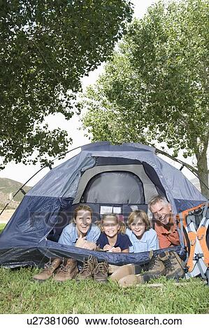 Family of four smiling from a tent View Large Photo Image Stock Image - Family of four smiling from a tent. Fotosearch