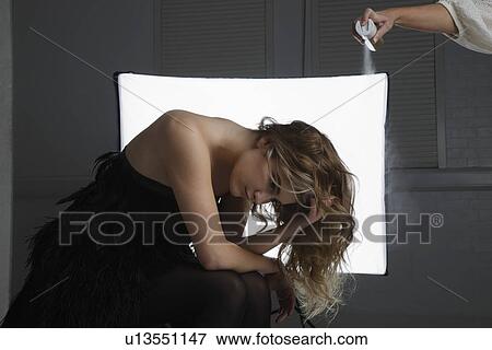 Fashion Model Having Hair Sprayed at Photo Shoot View Large Photo Image Stock Photo - Fashion Model Having Hair Sprayed at Photo Shoot. Fotosearch