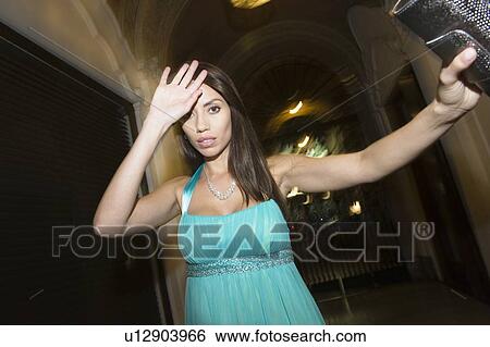 Stock Photograph - Female celebrity shielding face. Fotosearch