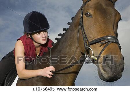 Female horseback holding bridle View Large Photo Image Stock Photography - Female horseback holding bridle. Fotosearch