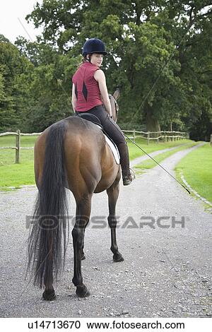 Female horseback rider sitting on brown horse View Large Photo Image Stock Image - Female horseback rider sitting on brown horse. Fotosearch
