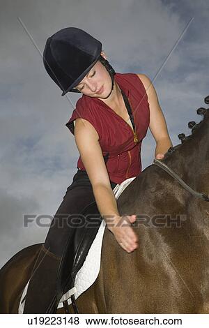 Female horseback rider stroking horse View Large Photo Image Stock Photo - Female horseback rider stroking horse. Fotosearch