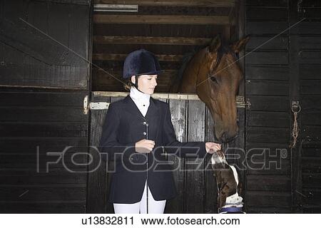 Female horseback rider with horse and dog in stable View Large Photo Image Stock Image - Female horseback rider with horse and dog in stable. Fotosearch