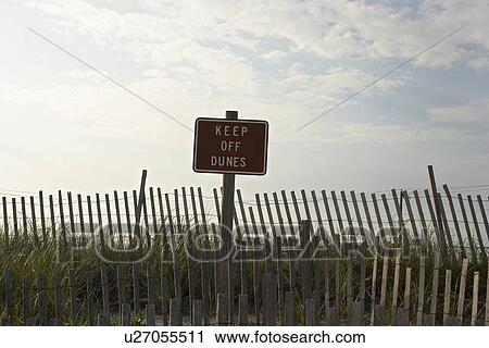 Fence and sign reading 'keep off dunes' View Large Photo Image Stock Image - Fence and sign reading 'keep off dunes'. Fotosearch