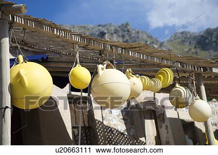 Fishing floats hanging on porch View Large Photo Image Stock Image - Fishing floats hanging on porch. Fotosearch