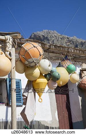 Stock Image - Fishing floats hanging on porch. Fotosearch