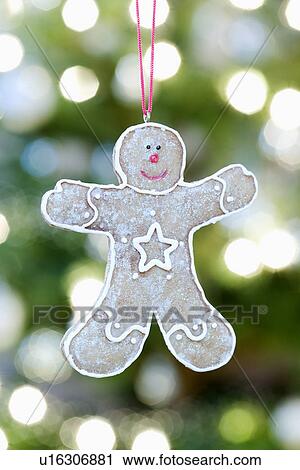 Gingerbread man hanging against Christmas lights View Large Photo Image Stock Image - Gingerbread man hanging against Christmas lights. Fotosearch