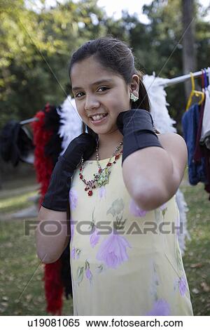 Girl (10-12) dressing up View Large Photo Image Stock Photography - Girl (10-12) dressing up. Fotosearch