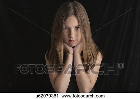 Girl (10-12) on black background portrait View Large Photo Image Stock Image - Girl (10-12) on black background portrait. Fotosearch