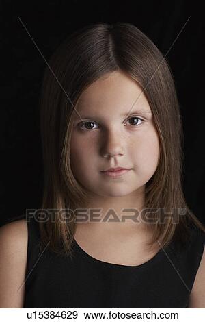 Stock Photo - Girl (5-6) on black background portrait. Fotosearch