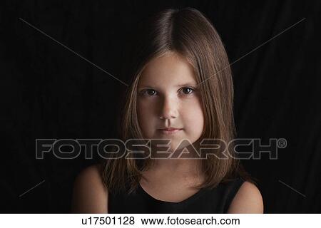 Girl (5-6) on black background portrait View Large Photo Image Stock Photo - Girl (5-6) on black background portrait. Fotosearch