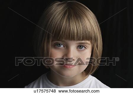 Stock Photo - Girl (5-6) on black background portrait close-up. Fotosearch