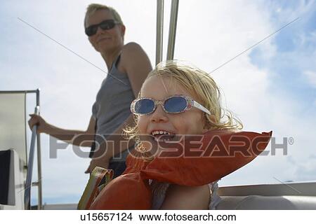 Girl (5-6) with mother on yacht focus on foreground View Large Photo Image Picture - Girl (5-6) with mother on yacht focus on foreground. Fotosearch