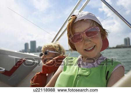 Stock Photo - Girl (7-9) on yacht. Fotosearch