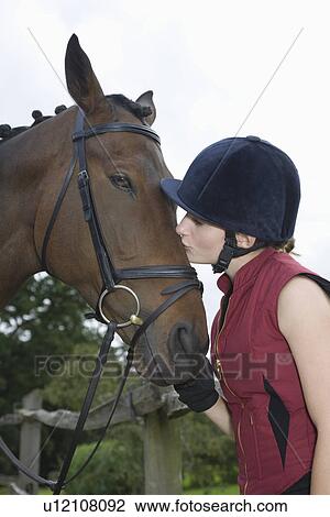 Girl kissing horse View Large Photo Image Stock Image - Girl kissing horse. Fotosearch