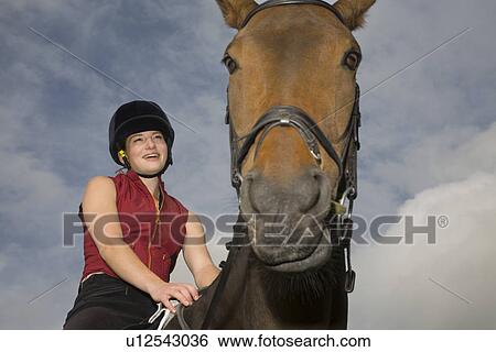 Stock Photograph - Girl on horseback. Fotosearch