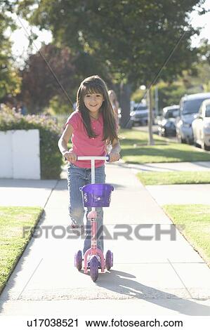 Girl on scooter View Large Photo Image Stock Image - Girl on scooter. Fotosearch