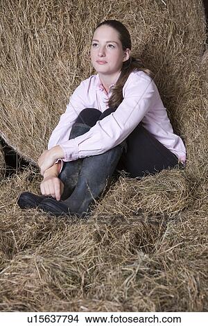Picture - Girl relaxing in barn. Fotosearch