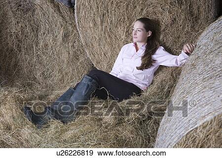 Girl relaxing in barn View Large Photo Image Stock Photo - Girl relaxing in barn. Fotosearch