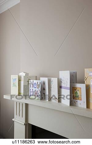 Stock Image - Greeting cards on top of fireplace. Fotosearch