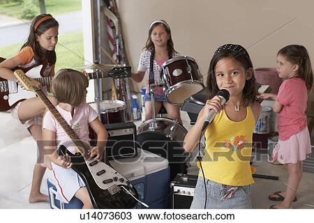 Group of girls (7-9) with instruments in garage View Large Photo Image Stock Image - Group of girls (7-9) with instruments in garage. Fotosearch