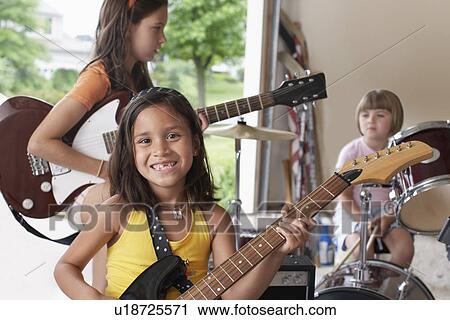 Group of girls (7-9) with instruments in garage View Large Photo Image Stock Image - Group of girls (7-9) with instruments in garage. Fotosearch