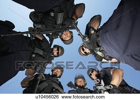 Stock Photograph - Group portrait of Swat officers standing in circle. Fotosearch