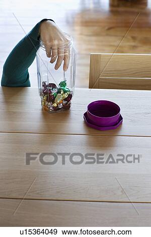 Hand of child taking candies from jar View Large Photo Image Stock Photo - Hand of child taking candies from jar. Fotosearch