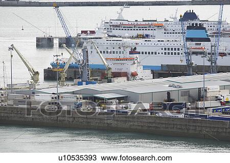 Stock Image - Harbor with trucks and ship. Fotosearch